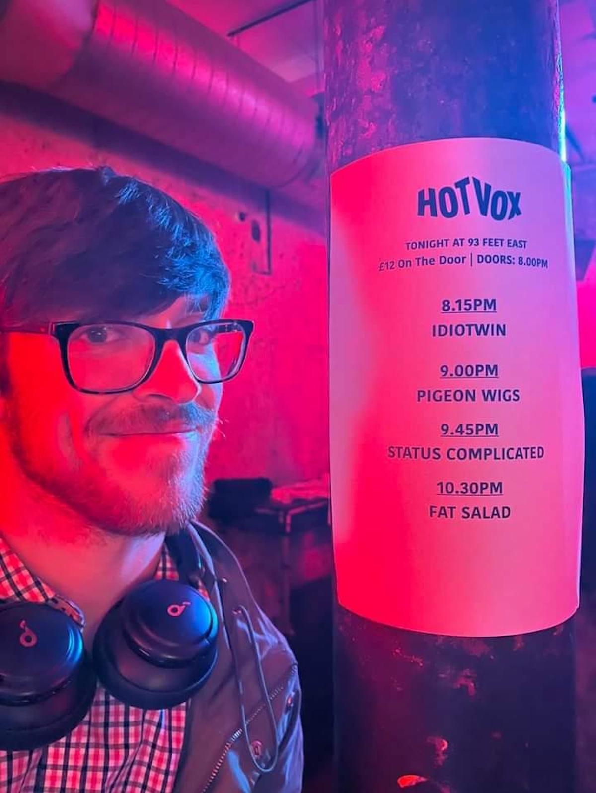 author Frederick Bloy poses next to a page with Idiotwin's set time for a show at Hot Vox, London
